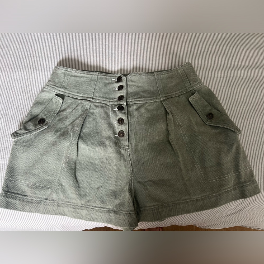 High-waisted faded green denim shorts by Sofie the label.